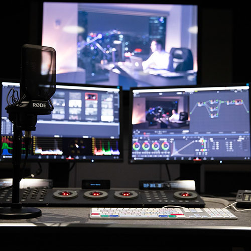 Video editing suite with 3 screens, voice recorder and multiple controls.
